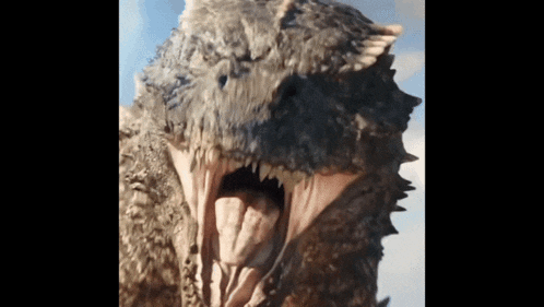 a close up of a dinosaur 's mouth with its tongue out
