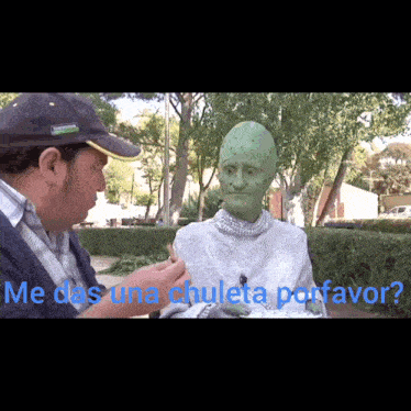 a man talking to a green alien in a park with the words me das una chuleta porfavor