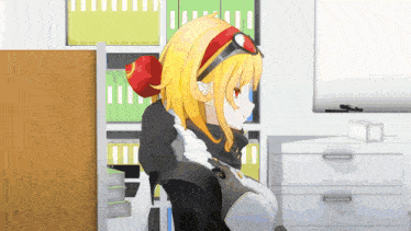 a girl with blonde hair and red eyes is sitting in a chair in front of a shelf with binders .