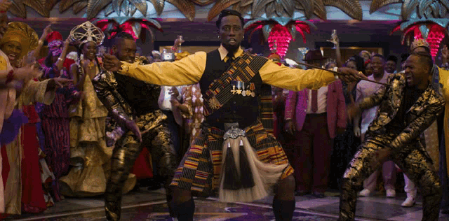 a man in a yellow shirt is dancing in front of a crowd of people