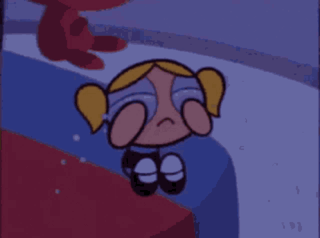 bubbles from the powerpuff girls is crying and covering her eyes .