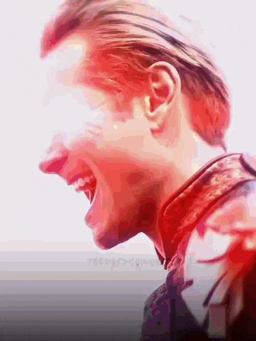 a close up of a man 's face with a red light coming out of his eyes