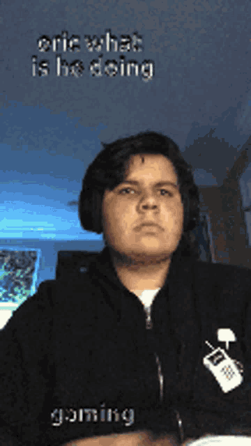 a man wearing headphones and a hoodie with a cell phone on it