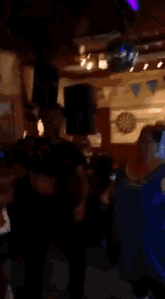 a woman in a blue dress is dancing with a man
