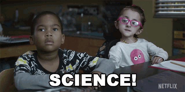 a boy and a girl are sitting at a table with the word science written on it