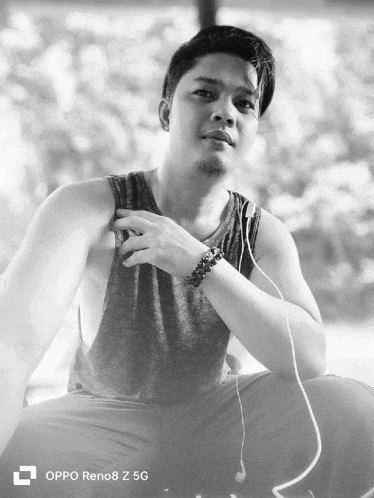 a black and white photo of a man with an oppo reno8 z 5g logo