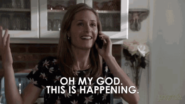 a woman is talking on a cell phone and saying oh my god this is happening
