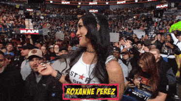 roxanne perez stands in front of a crowd of people