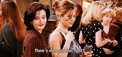 two women are standing next to each other at a party .