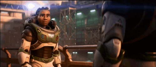 buzz lightyear is standing next to a man in a space suit