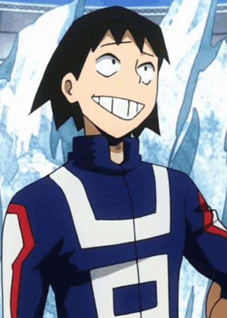 a close up of a cartoon character with a big smile on his face standing in front of a mountain .