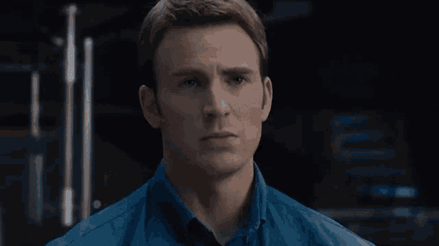 a man in a blue shirt is looking at the camera with the word together above him