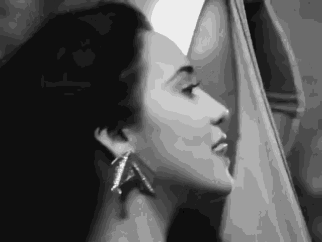 a black and white photo of a woman 's face