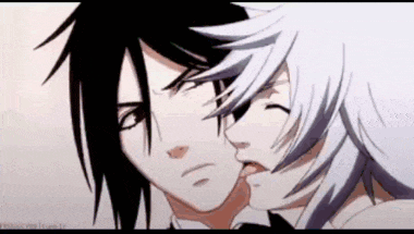 a black and white anime character kissing another character 's cheek .
