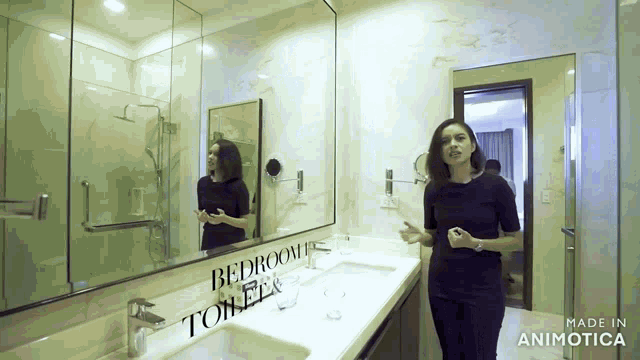 a woman is standing in a bathroom with the words bedroom toilets written on the wall