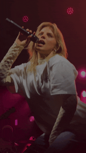 a woman wearing a white t-shirt with a jaguar on it