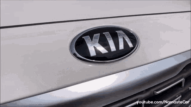 a close up of a kia emblem on the front of a car