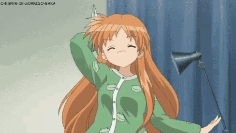 a girl with long red hair is wearing a green pajama top