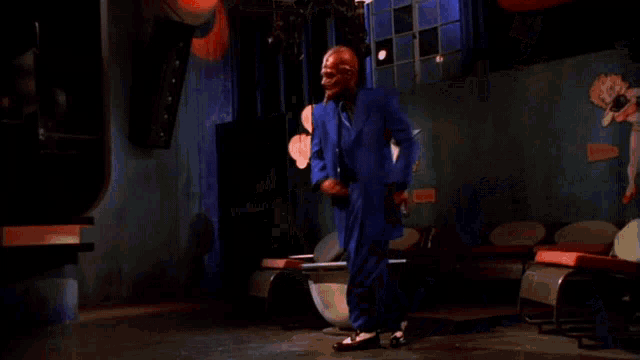 a man in a blue suit with a red mask on his head