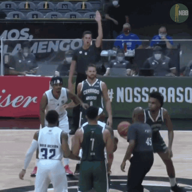 a basketball game is being played in front of a banner that says " nosso brasil "