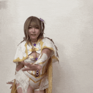 a woman in a white and gold costume is waving