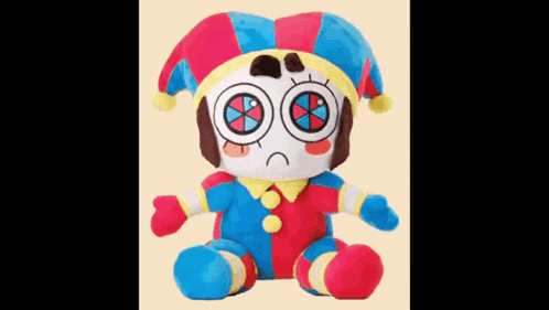 a stuffed clown with a sad face is sitting on a table