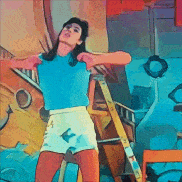 a woman in a blue shirt and white shorts is standing next to a yellow ladder ..