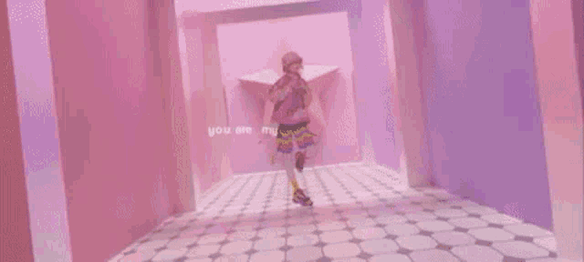 a person is standing in a pink and purple room with a microphone in their hand .