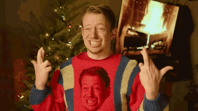 a man wearing a red and blue sweater with a red face on it