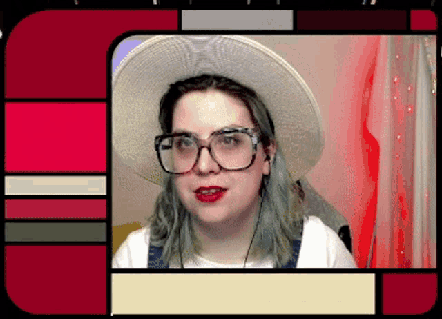 a woman with blue hair and glasses wearing a white hat and overalls