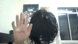 a person 's hand has a red butterfly tattoo on it