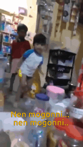 two children are standing in a store with the words " nen mogooni ... nen mogooni " above them