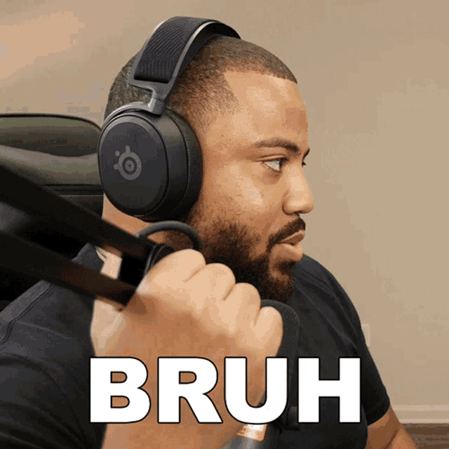 a man wearing headphones is holding a microphone and the word bruh is above him