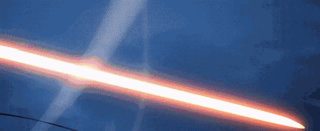 a red light beam is shining on a blue surface