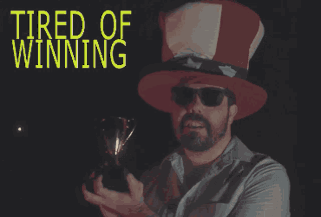 a man wearing a top hat with the words tired of winning written above him