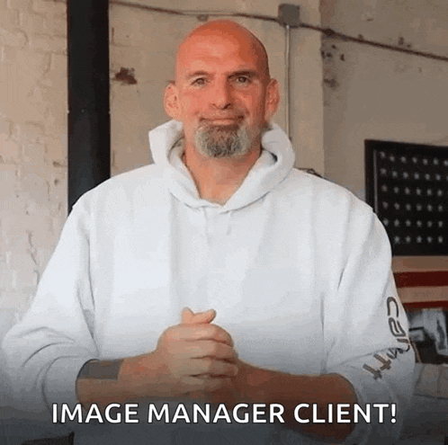 a bald man with a beard is wearing a white hoodie and talking to the camera .