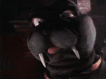 a woman is holding a stuffed animal in the dark