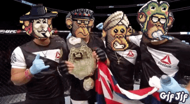a group of fighters wearing reebok shirts pose for a photo