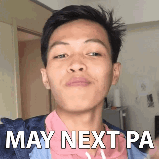 a man in a pink shirt has the words may next pa written on his face