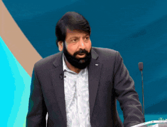 a man with a beard is standing in front of a podium