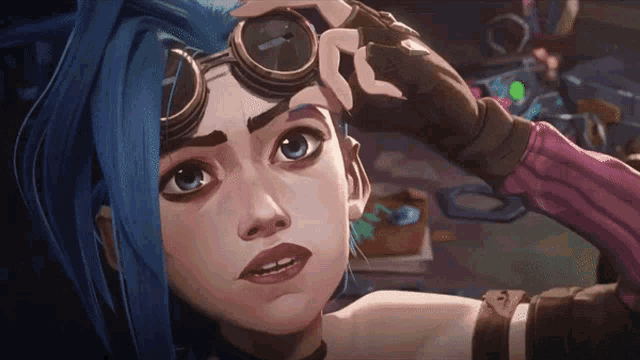 a woman with blue hair and goggles on her head