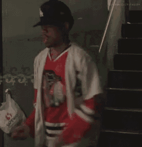 a man holding a bag that says saturday