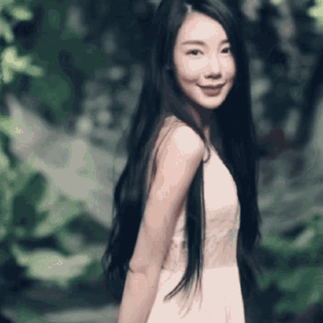 a woman with long black hair in a white dress