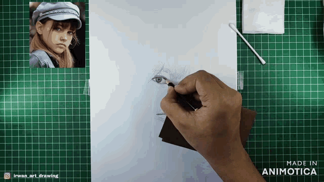 a person is drawing a woman 's face on a piece of paper that is made in animotica