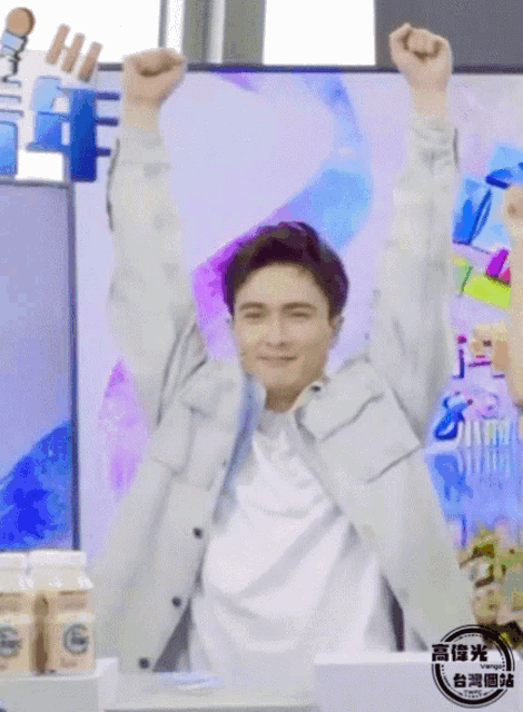 a man with his arms in the air has a sign that says hi on it