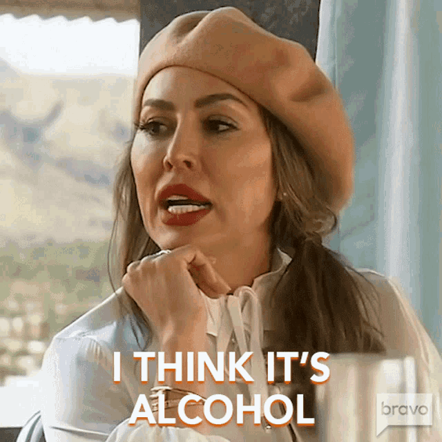 a woman wearing a beret and a white shirt says i think it 's alcohol