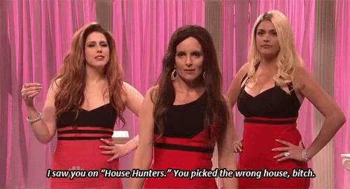 three women in red dresses are standing next to each other on a pink curtain .