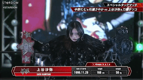 a woman is holding a stardom wrestling belt in her hand