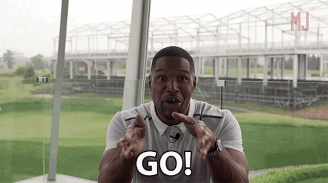 a man in a white shirt is saying go