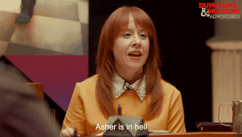a woman with red hair is sitting at a table with a sign that says dungeons and dragons adventures